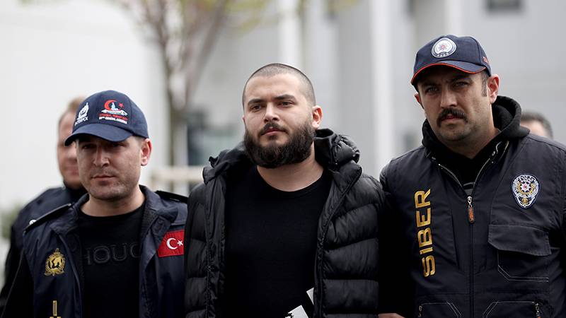 Thodex scam CEO Faruk Fatih Özer being escorted by police after his arrest and extradition to Turkey to face charges for the $2 billion fraud.