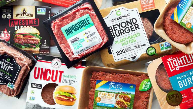 An assortment of popular plant-based meat products, including Impossible Burger, Beyond Meat, and Lightlife.
